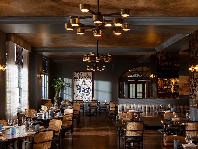 A room with tables and chairs at HEW Parlor & Chophouse in Dunedin FL