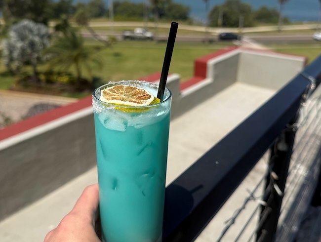 a glass of a blue tropical version of a margarita